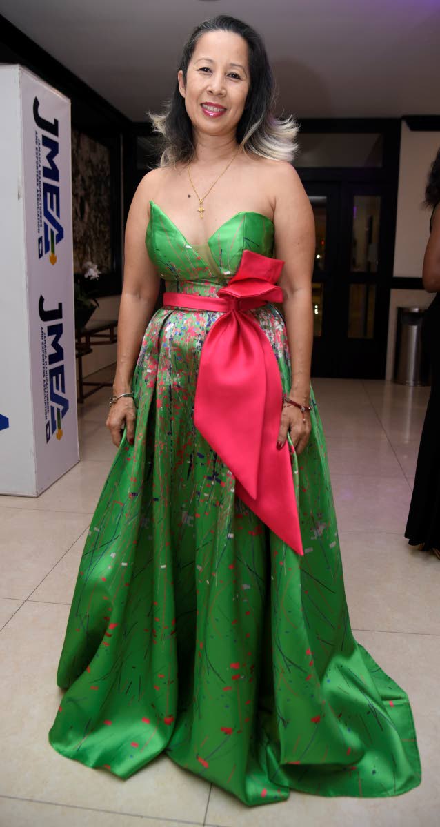 Serena Lue-Whittingham, senior relationship manager, corporate banking, NCB, opts for a green ballgown with an oversized bow.