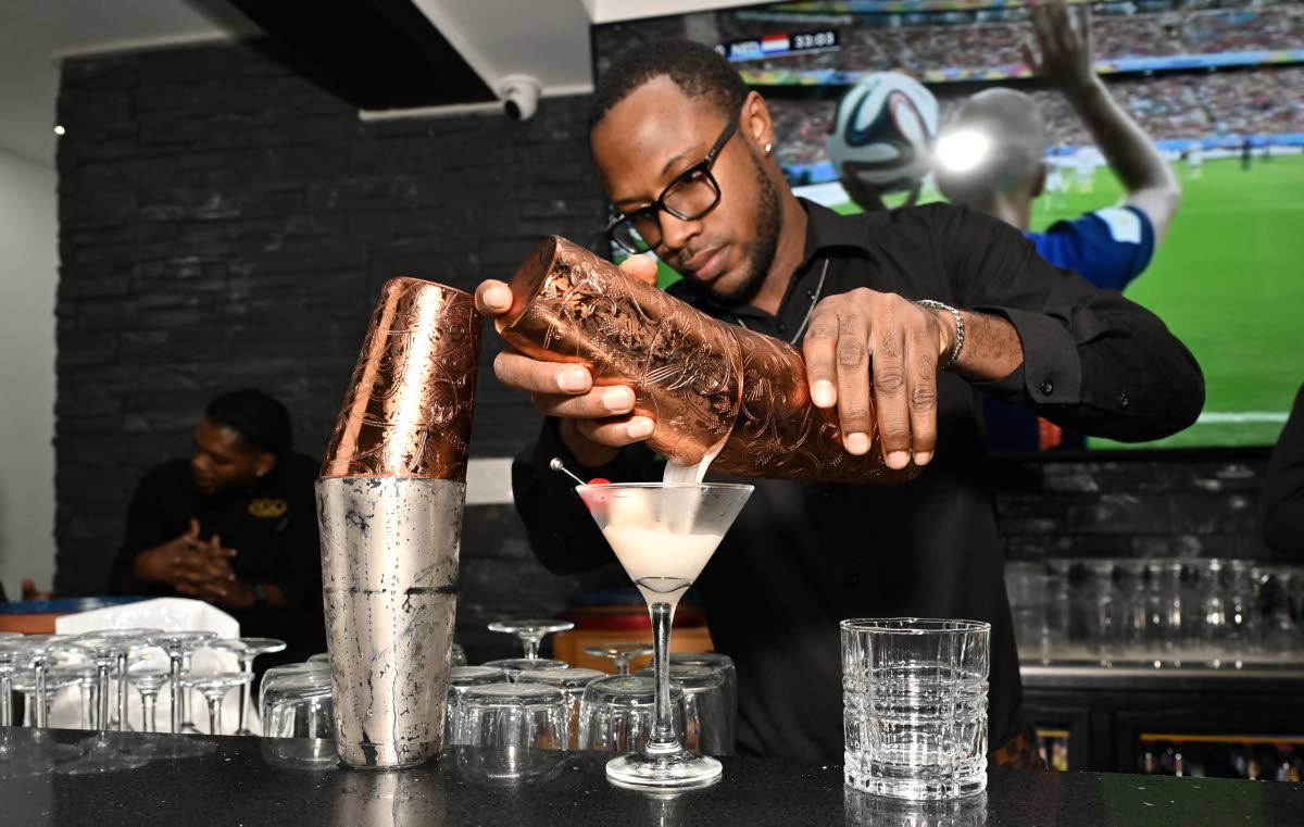 Wayne Gayle pours a margarita. 