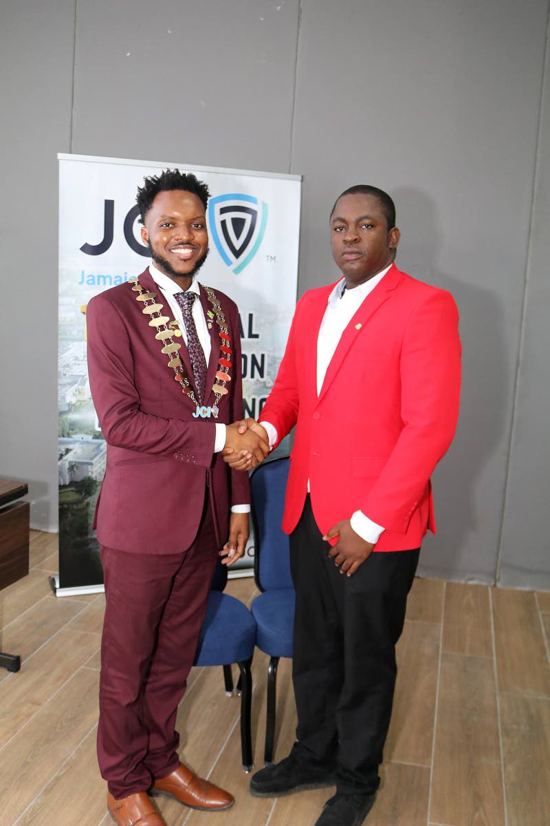 Dr Farin Williams (right), newly elected national president of JCI Jamaica, receives congratulations from outgoing National President Marklon Bedward after his election at JCI Jamaica’s annual convention at the Grand Palladium Resort & Spa in Lucea, Hano