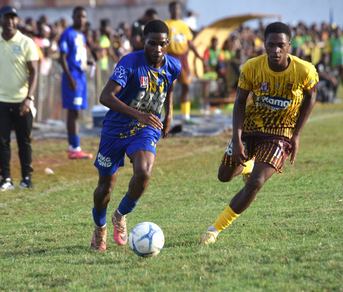 Clarendon College's Patrick Page (left) tries to outrun Manchester High’s Brandon Brown during  their ISSA Ben Francis KO quarterfinal match at Manchester High's playing field on Saturday, October 3, 2026.