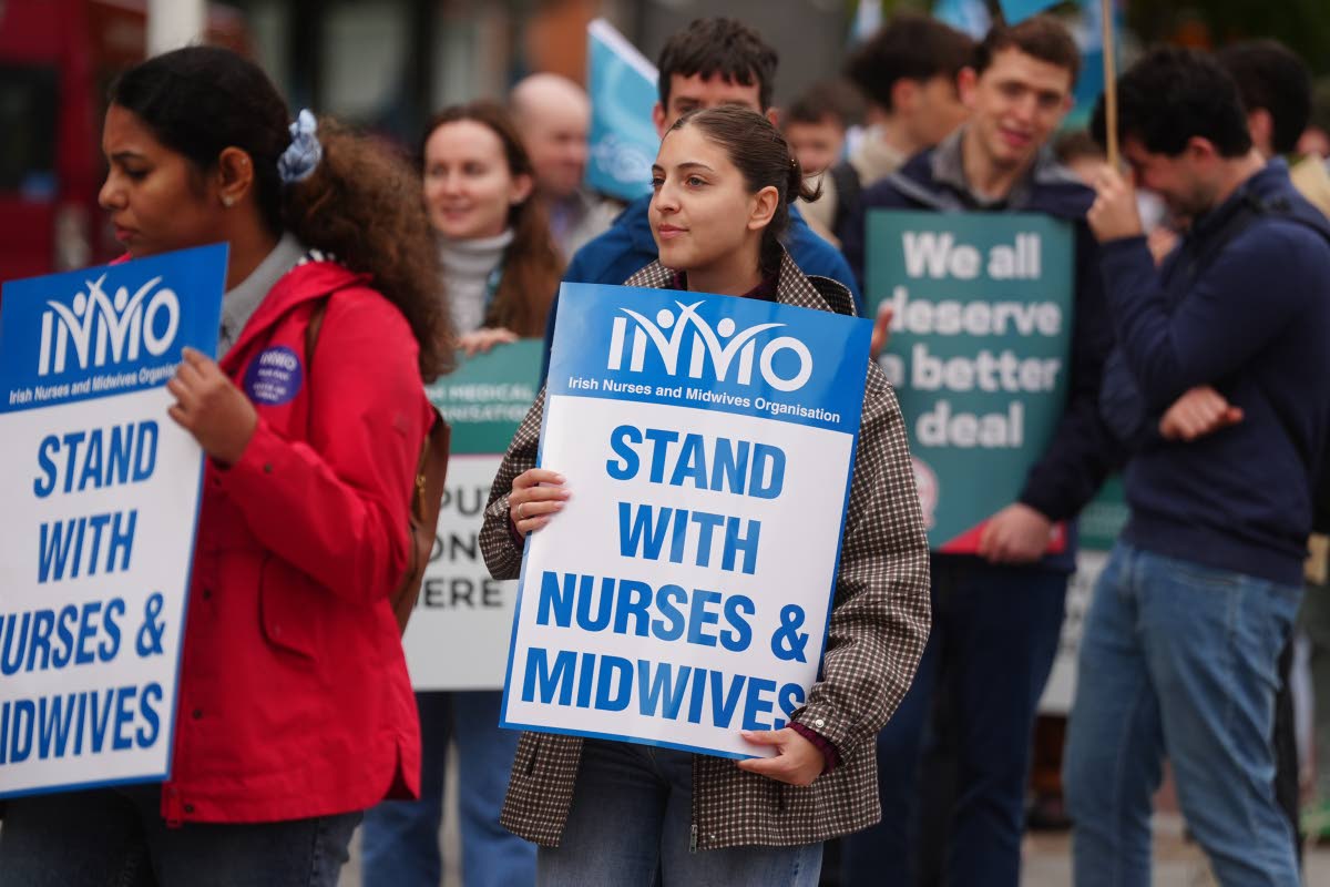 Public sector workers take part in a 24-hour strike over delays in agreeing a new public sector pay deal at Mater Hospital, Dublin, Ireland, Wednesday Oct. 14, 2026. (Brian Lawless/PA via AP)