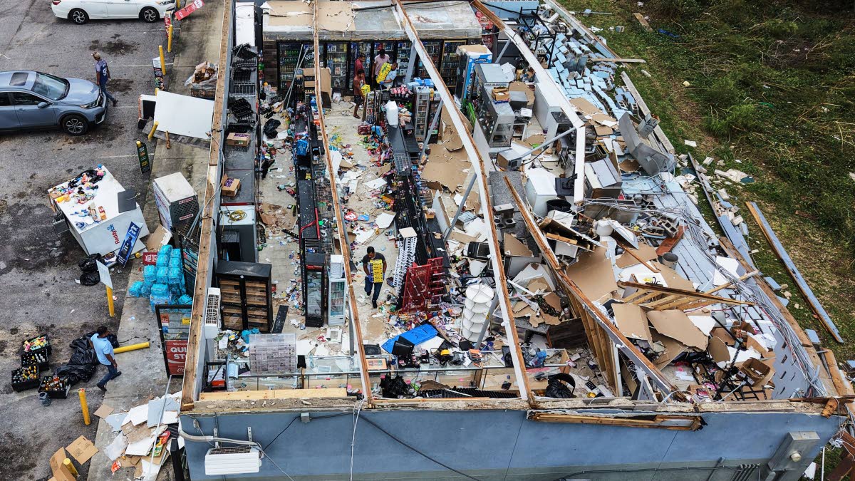 People salvage the contents of their destroyed mini mart in the aftermath of Hurricane Isaias in Milton, Florida, Saturday, October 10, 2026.