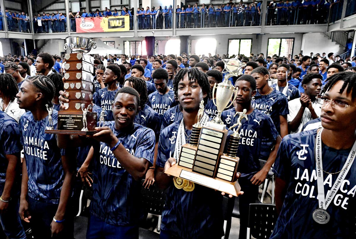 Michael-Andre Edwards (second left), captain of Jamaica College’s track and field, along with schoolmates and other members of the team celebrating their ISSA GraceKennedy Boys’ Champs 2026 title.