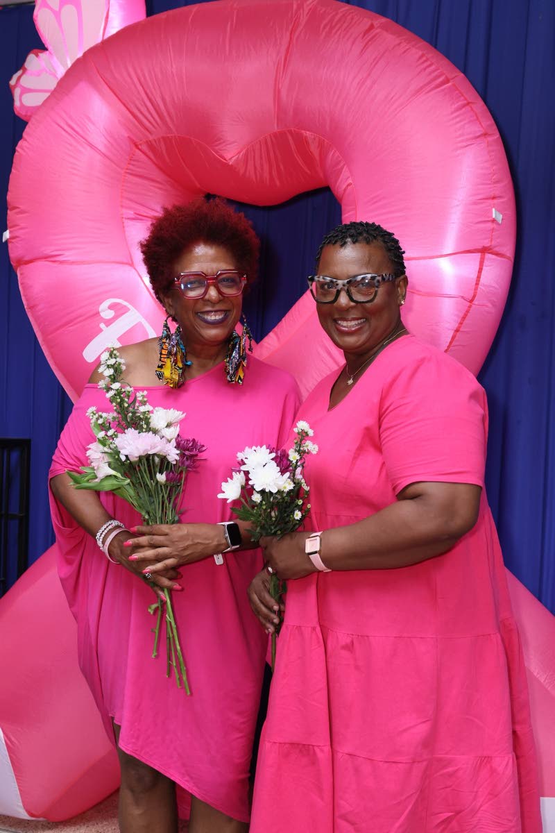 President of the Jamaica Reach to Recovery (JR2R), Sandra Samuels (left), greets breast cancer survivor, Diana Walters-Heron, as they flaunt their bouquets during a floral arrangement session at the JR2R’s monthly meeting in partnership with Sygnus.