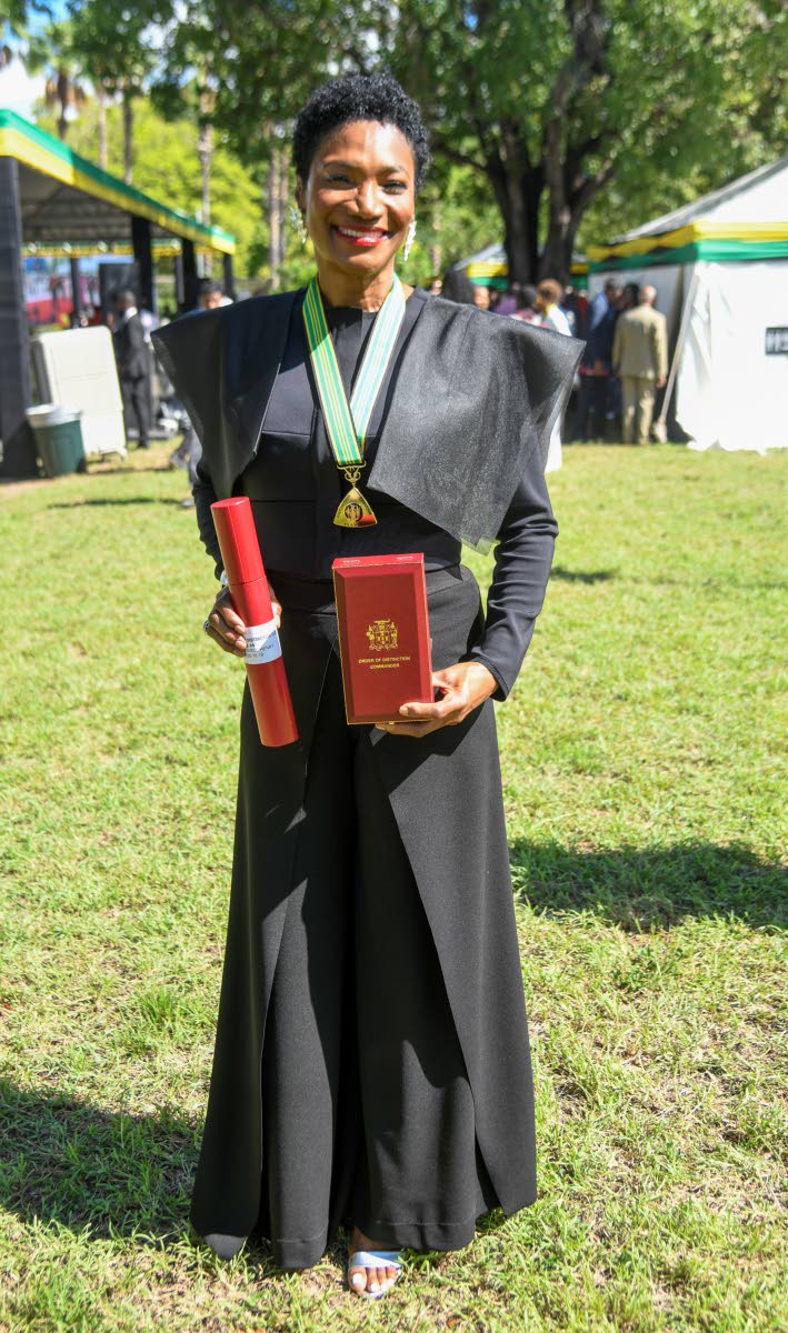 Audrey Tugwell Henry, Scotia Group Jamaica president and CEO, puts her own spin on power dressing in a jumpsuit by Toronto-based Freda’s, as she is conferred with the Order of Distinction in the rank of Commander.
