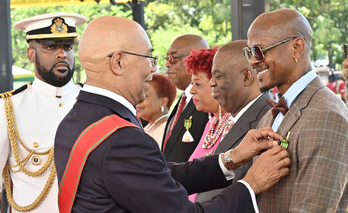 Governor General Sir Patrick Allen presents Clifford Roy ‘Mr Vegas’ Smith with the insignia of the Order of Distinction in the rank of Officer. 