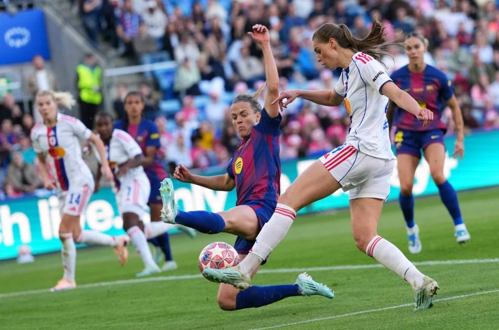 Lyonnes' Jule Brand, right, attempts a shot at goal past Barcelona's Irene Paredes during the Women's Champions League final soccer match between FC Barcelona and OL Lyonnes in Oslo, Norway, Saturday, May 23, 2026.Lyonnes' Jule Brand, right, attempts a sho