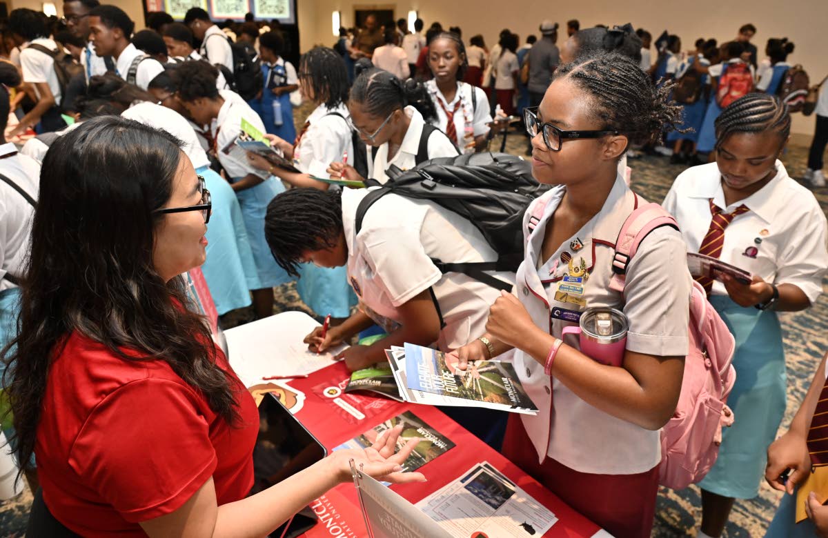 Naomi An (left), assistant director of the International Recruitment Office of Global Engagement at Montclair State University, speaks with students at the EducationUSA College Fair.