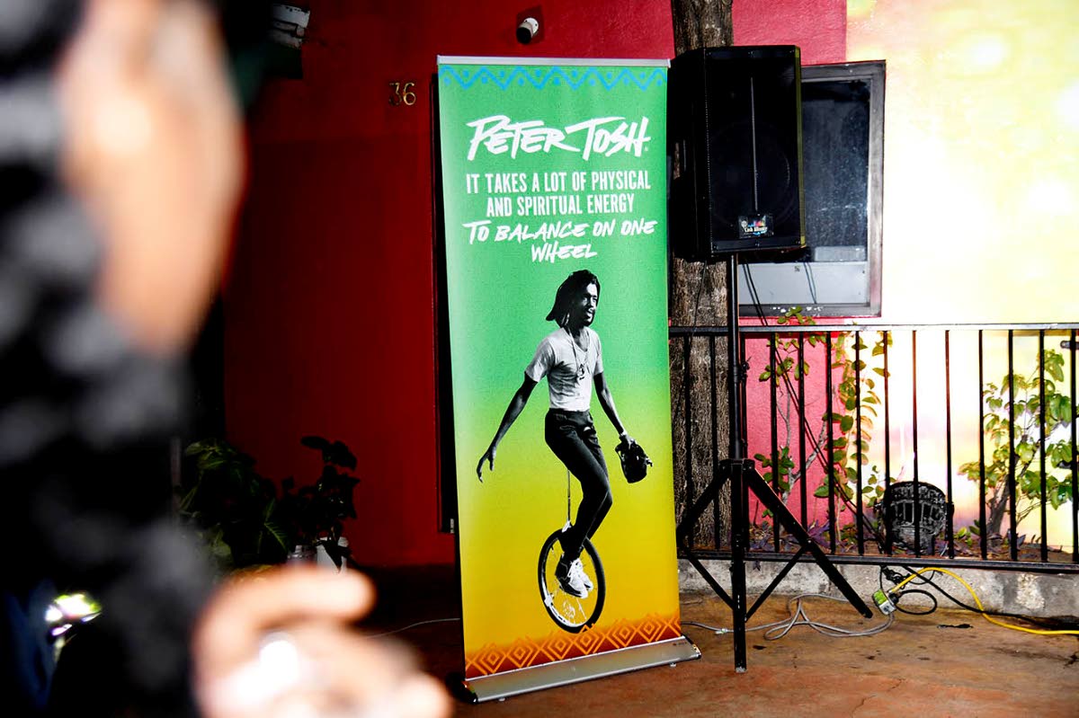 A guest admires a picture of Peter Tosh at the Touch of Tosh: Legalise it 50th anniversary held on October 16, at the Peter Tosh museum in Kingston.