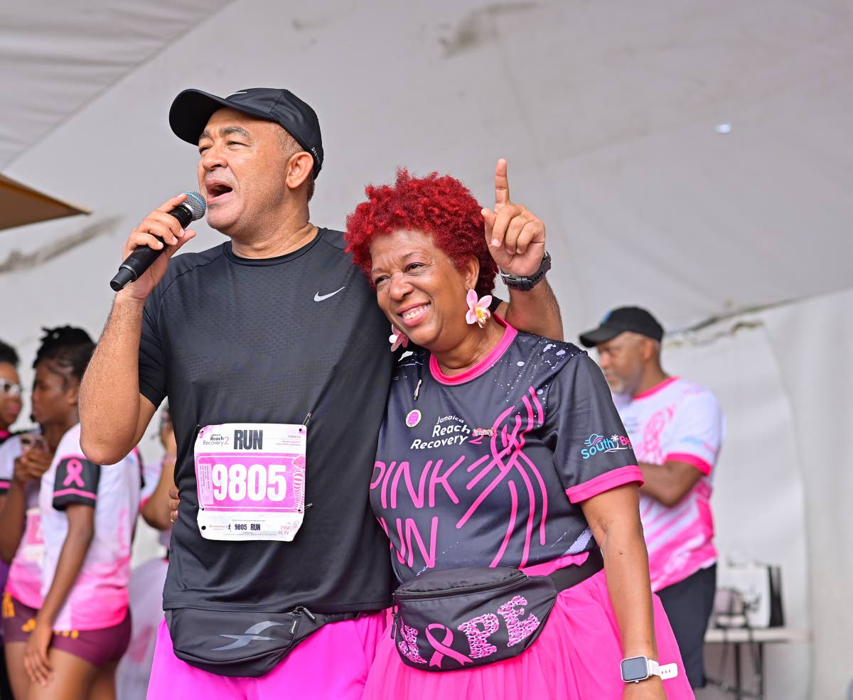 Minister of Health and Wellness,  Dr Christopher Tufton, shares a warm moment with Jamaica Reach to Recovery President Sandra Samuels as he congratulates her and the team on another successful staging of the Pink Run.