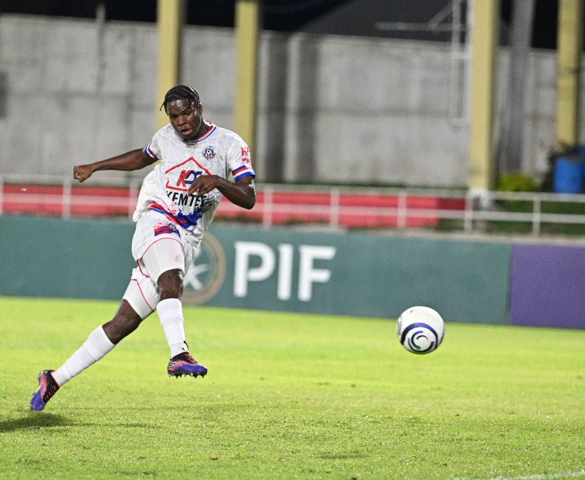 Portmore United’s Tedj Bryan takes the shot that beats Violette AC goalkeeper Gooly Elien during the Concacaf Caribbean Cup second-leg semi-final fixture at Sabina Park last night. Portmore lost the tie 201 but won 4-3 on aggregate.