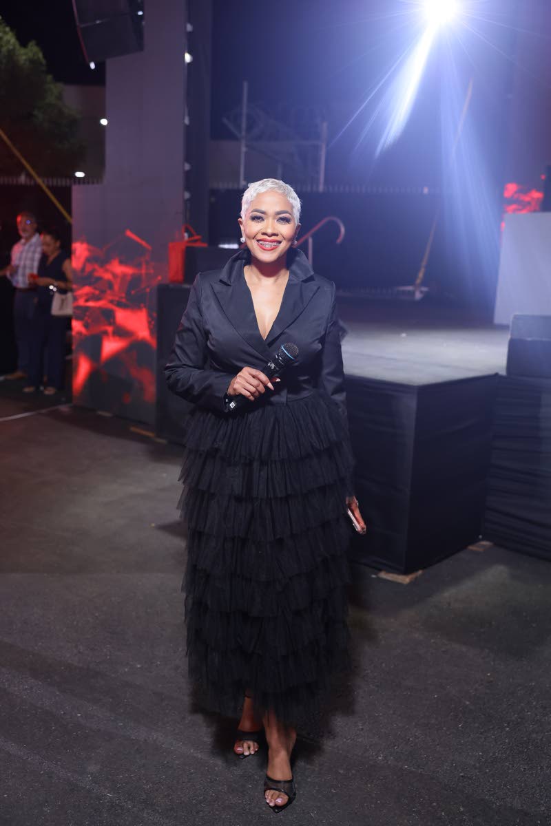 Event host Deborah ‘Debbie’ Bissoon dons a black blazer dress with tiered tulle mesh ruffles. 