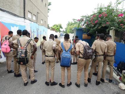 In this file photo, a group of students  is seen standing at their school gate.