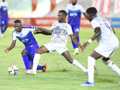 
Franco Celestin (left) from Mount Pleasant is tackled for the ball by Jahmilio Rigters (right) from Cavalier during the Jamaica Premier League final at the National Stadium last season.