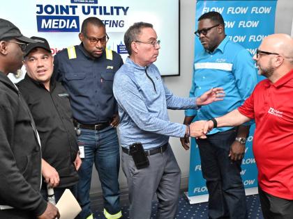Matthew Samuda (second left), minister of water, environment and climate change; and Daryl Vaz (third right), minister of science, energy, telecommunications and transport; speak with from left Stephen Shaw, communications specialist, at the NWA; Hugh Gran