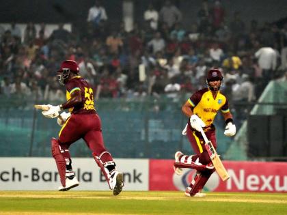 Former West Indies captain, Rovman Powell (left), runs a single with current captain, Shai Hope, on his way to an unbeaten 44 and an unbroken 83-run partnership to help his side claim the first T20I against Bangladesh at the Bir Sreshtho Flight Lieutenant 