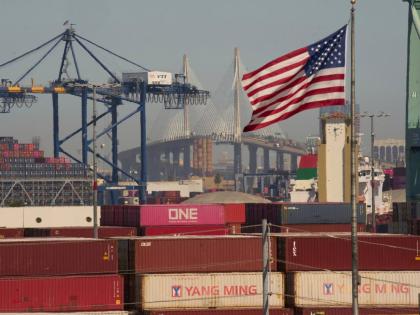 Containers with Yang Ming Marine Transport Corporation, a Taiwanese container shipping company, are stacked up at the Port of Los Angeles, with the Long Beach International Gateway Bridge seen in the background, on Wednesday, April 9 in Los Angeles.  AP 
