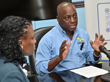 Audley Gordon, executive director of the National Solid Waste Management Authority (NSWMA), speaks to the media while Sheenique Johnson, corporate services director, looks on during an NSWMA press briefing on new operational measures to expedite debris rem