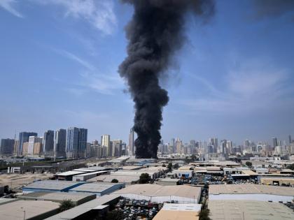 A black plume of smoke rises from a warehouse at the industrial area of Sharjah City in the United Arab Emirates following reports of Iranian strikes in Dubai, United Arab Emirates on March 1, 2026. (AP Photo/Altaf Qadri)