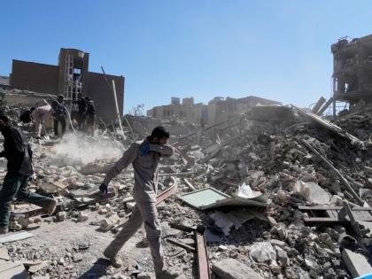 A group of men inspect the ruins of a police station struck Monday amid the U.S.–Israeli military campaign in Tehran, Iran.
