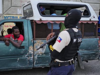 A police officer stands guard in Port-au-Prince, Haiti, Tuesday, March 3, 2026. (AP Photo/Odelyn Joseph)