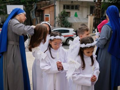 Children and nuns gather outside the Holy Family Catholic Church before attending a mass ahead of Christmas celebrations in Gaza City.