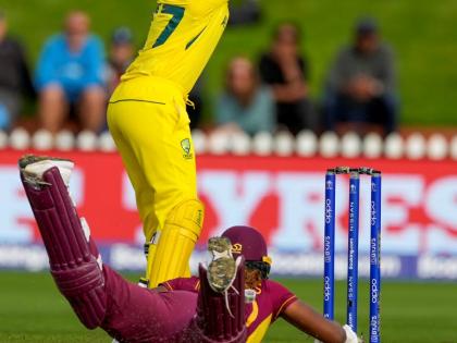 Alyssa Healy of Australia (top) takes a return throw as Hayley Matthews of the West Indies slides to make her ground during their Women’s Cricket World Cup semi-final match in Wellington, New Zealand, on March 30, 2022.