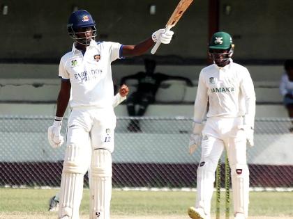Barbados Pride’s Kevin Wickham raises his bat after scoring 150 against Jamaica Scorpions on the opening day of their West Indies Championship cricket match at Chedwin Park in St Catherine on Sunday.