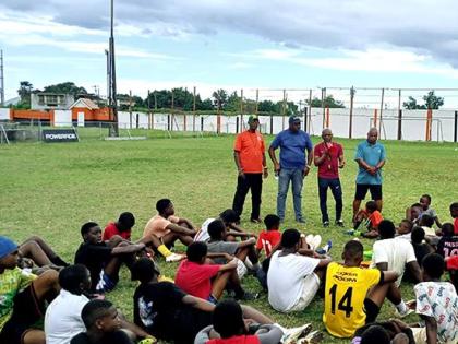 Members of the Jamaica Diaspora Football Association (JDFA)  (top, from left) Colonel Bruce Bartlett, Raymond Anderson, coach Calvin Salmon and president Michael Barnes address young footballers at the JDFA grassroots camp at the Edward Seaga Sports Comple