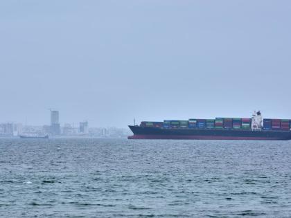 A container ship is seen in the Strait of Hormuz off the coast of Qeshm Island, Iran, Saturday, April 18, 2026. (AP Photo/Asghar Besharati)