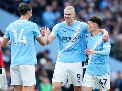 Manchester City's Erling Haaland celebrate with his teammates Nico Gonzalez and Phil Foden at the end of the English Premier League football match between Manchester City and and Arsenal, in Manchester, England, Sunday, April 19, 2026. (AP Photo/Dave Thomp