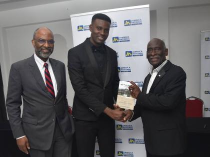 Reverend Ulit Brackett (right) holds a copy of his new book with Shevauni Powell (centre), Mr Supranational Jamaica 2025 and former head boy of Mile Gully High School. Sharing the moment is Earl Jarret, chief executive officer of the JN Group.