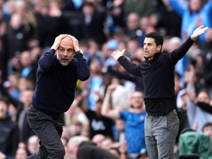 Manchester City’s head coach Pep Guardiola and Arsenal manager Mikel Arteta react during their English Premier League  match in Manchester, England, yesterday.
