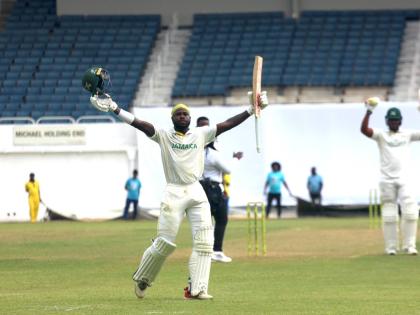 Jamaica Scorpions batsman Kirk McKenzie celebrates scoring a century against the Barbados Pride in thge second-round of the West Indies Championships at Sabina Park yesterday.