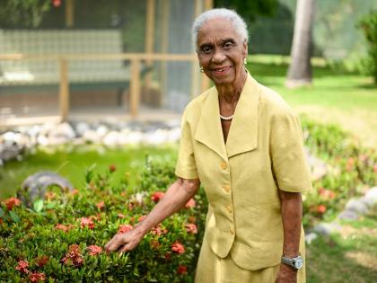 Dr Mavis Gilmour-Petersen poses in her garden at her St Andrew home on April 16.