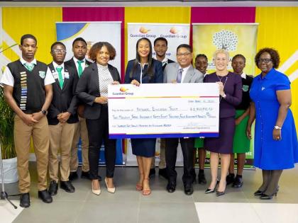 Students of Frome Technical High School and their principal look on as (from left) Executive Director of the National Education Trust, Latoya Harris-Ghartey; State Minister in the Ministry of Education, Skills, Youth and Information, Rhoda Moy Crawford; Gu