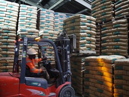 A forklift operator loading cement for transport.
