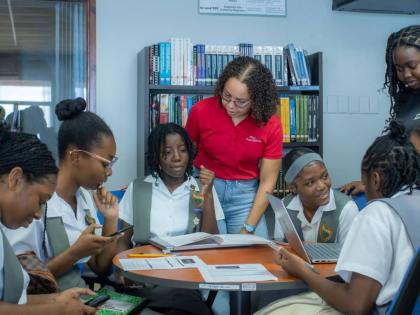 Avryl Francis, Digicel Foundation board director and security operations manager, engages with participants during the Girls in ICT Day AI and Climate Change Hackathon on Thursday, hosted by the Digicel Foundation and STEMSpark Solutions.