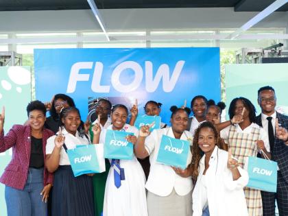 The winning team in Flow’s Girls in ICT Day AI workshop pitch competition celebrates with Maya Walrond (left), senior director, digital transformation, Flow; Rosalynn Williams (second from left), B2B service manager, Flow; Stacey Hines (third from right)