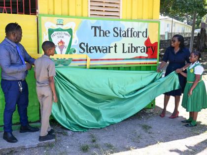 Principal of Duckenfield Primary and Infant School in St Thomas, Stafford Thomas, and education officer for Region Two in the Ministry of Education, Skills, Youth and Information, Marcia Dallas-McKenzie, unveil the sign to the institution’s newly opened 