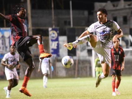 Ricardo Thomas (second left) of Arnett Gardens  and Shad San Millan (second right) of Cavalier  compete for the ball during their Jamaica Premier League football match at Anthony Spaulding Sports Complex on Thursday. Arnett Gardens won 2-1.