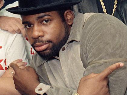 FILE - Run-D.M.C.'s Jason Mizell, Jam-Master Jay, poses with teenagers gathered at New York's Madison Square Garden, Oct. 7, 1986, in New York City. (AP Photo/G. Paul Burnett, File)