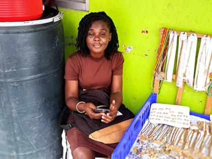Franceita Renford at her workstation on a corridor along West Street in Port Antonio, Portland.