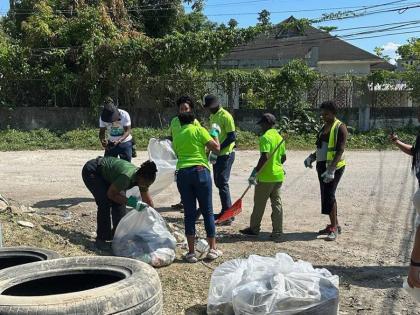 Community members join in on the National Solid Waste Management Authority (NSWMA) Earth Day clean-up initiative in Hoist Brissett, Hanover,  on Wednesday, April 22.