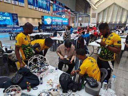 Contributed 
Jamaica Drone Soccer team members get some help from the South Korean team, who provided valuable assistance in resolving software issues during the Federation of International Drone soccer Association (FIDA) Intercontinental Cup in South Kore