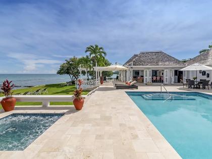 An aquatic playground of a beach, hot tub, and pool unite in one place. 