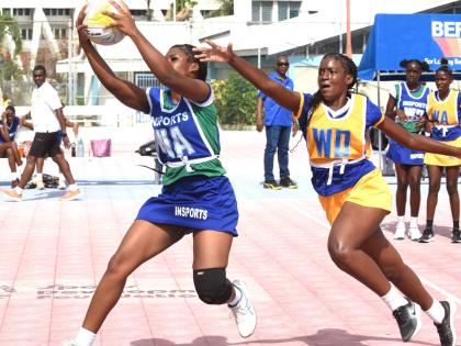 Remanique Edwards (left) of Denbigh High and Selena Grant (right) of Gaynstead High compete for the ball during their Insports Challenge Cup Netball semi-final at the Leila Robinson Court last Friday.