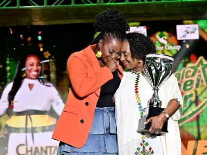 Minister of Culture, Gender, Entertainment and Sport Olivia Grange presents the winning trophy to an emotional Chantal Smalling Stephenson (left), the winner of the Jamaica Gospel Star 2026.