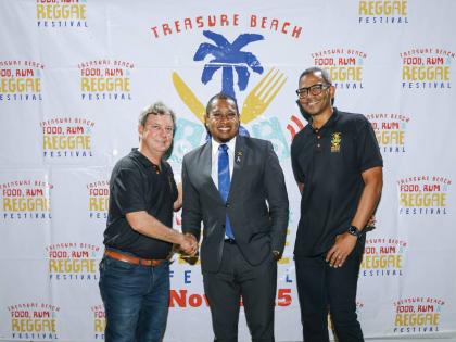 Directors of the Treasure Beach Food, Rum & Reggae Festival, Gregory Wright (far right) and Jason Henzell (far left) are joined by Minister of Agriculture, Fisheries and Mining Floyd Green, at the launch of the 2025 event. The festival organisers recently 