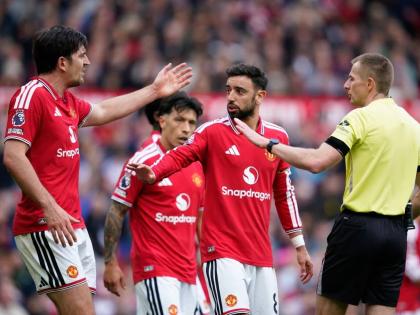 Manchester United’s Harry Maguire (left) argues with referee Michael Salisbury during the English Premier League  match between Manchester United and Nottingham Forest in Manchester, England yesterday. At centre is Bruno Fernandes. 